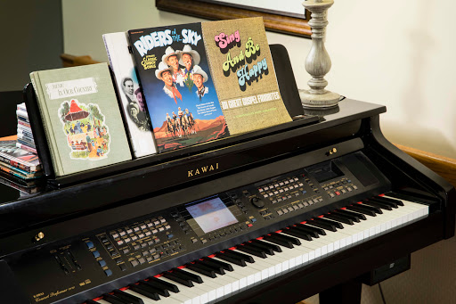 A stylish piano with music sheets for various performances.