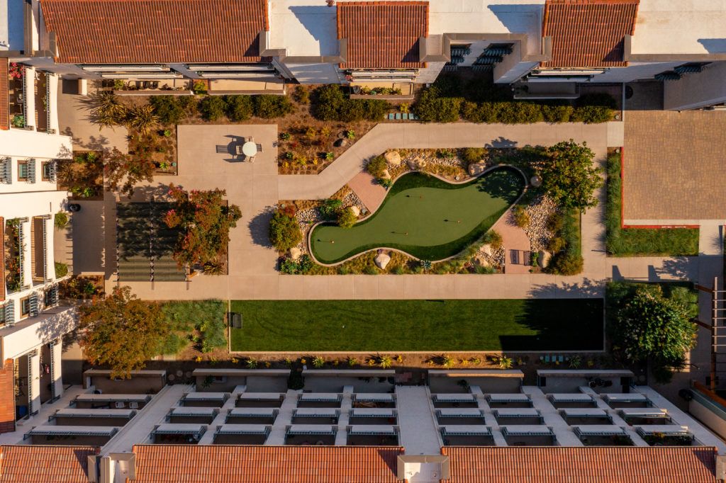 A stunning aerial view of a landscaped rooftop garden in an urban setting.
