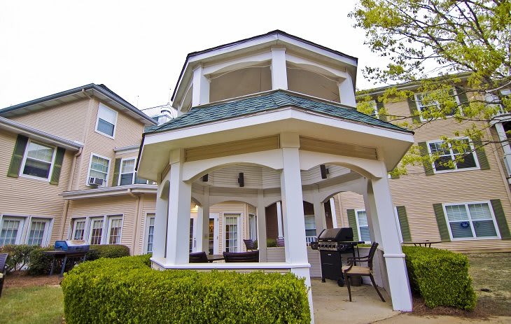 A charming gazebo provides a cozy outdoor seating area in a well-maintained garden.