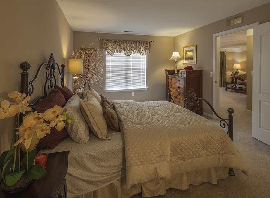 A cozy bedroom with elegant furnishings and soft lighting.
