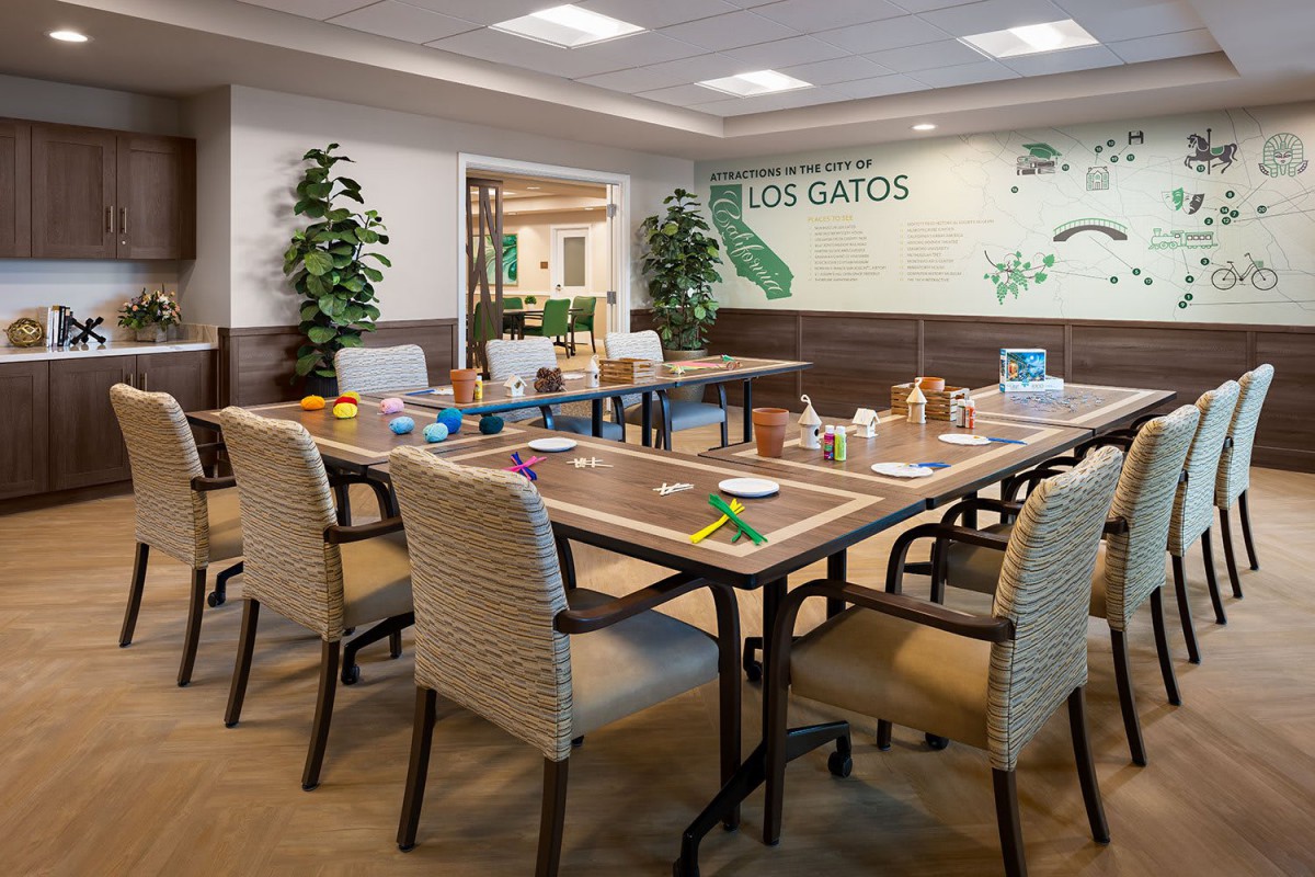 A well-arranged conference room with a large meeting table, chairs, and decorative plants.
