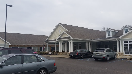 A peaceful residential building with a welcoming entrance, set against a cloudy backdrop.