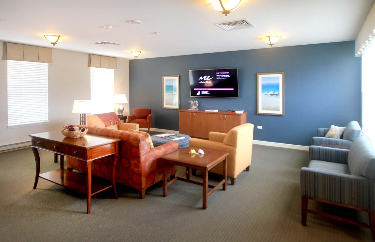 A cozy and modern living room with comfortable seating and a large television.