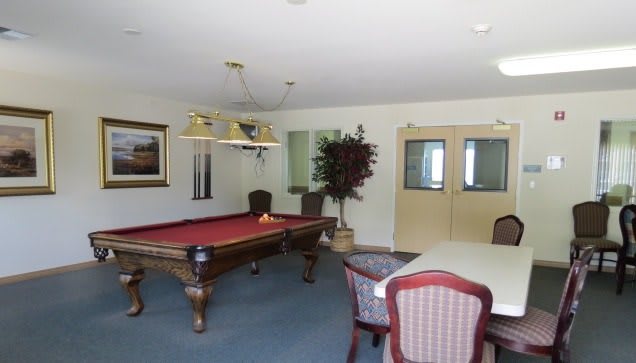 A recreational room featuring a pool table and seating area.