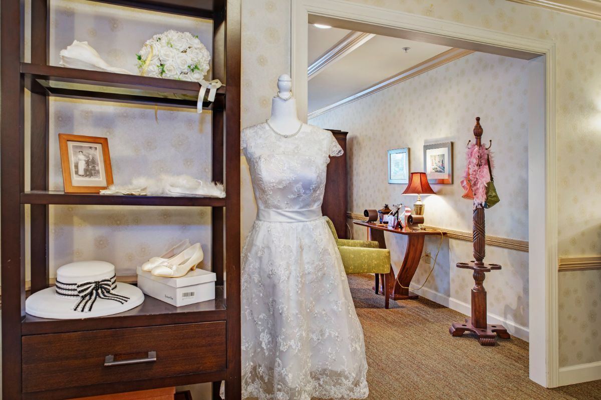 A beautifully designed wedding dress displayed on a mannequin in a stylish bridal shop.