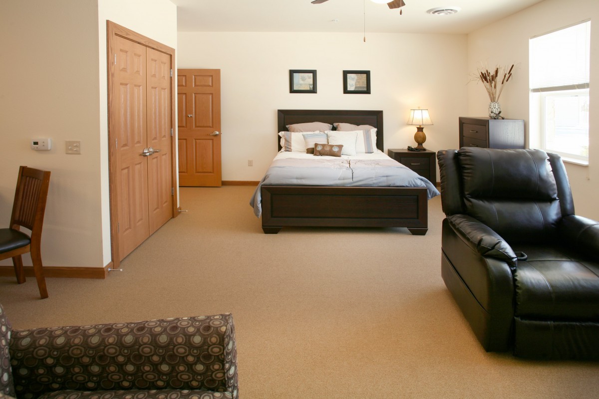 Spacious bedroom with a large bed and comfortable seating area.