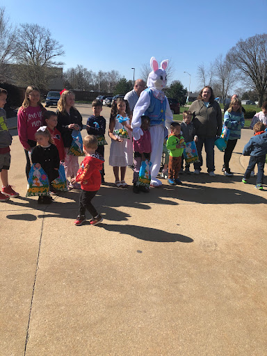 A joyful gathering of families and children celebrating Easter, with the Easter Bunny making the day extra special.
