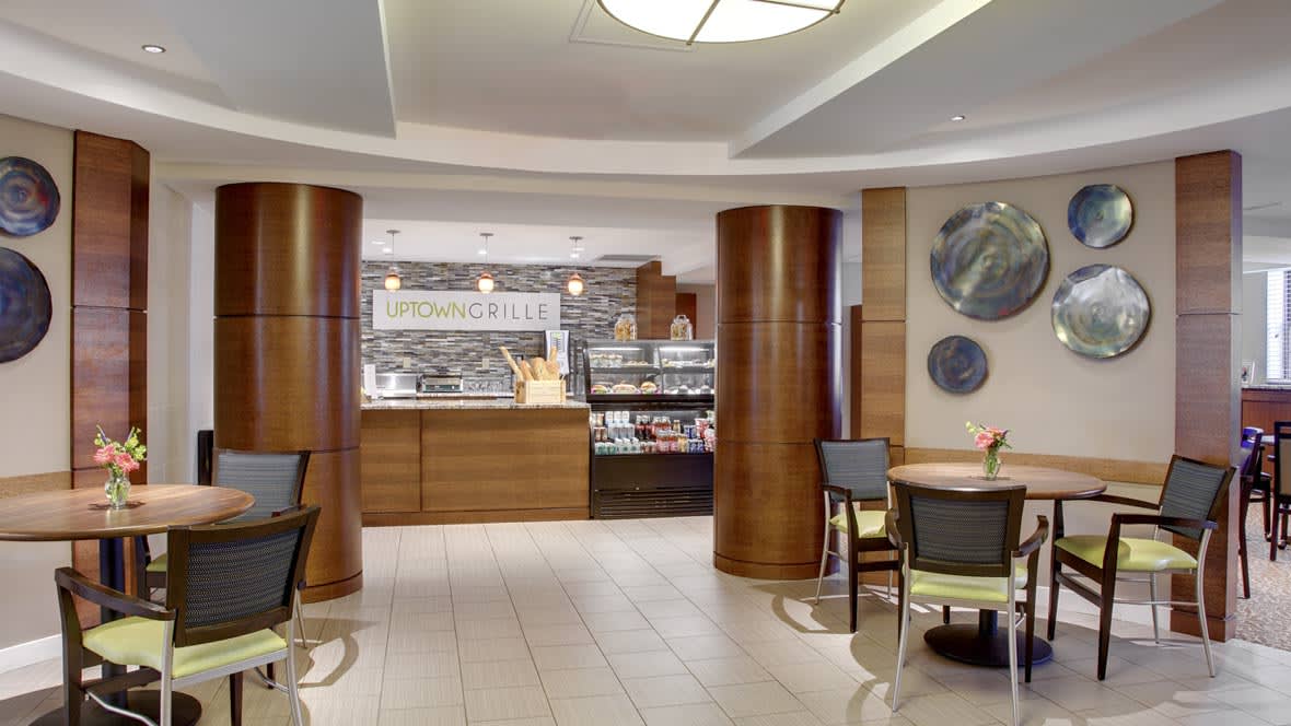 A modern cafe interior with a service counter and seating area.