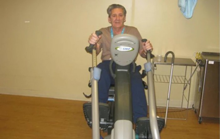 A person exercising on a cardio machine in a gym.