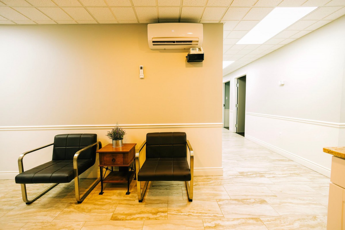 A quiet waiting area with chairs and an air conditioner.