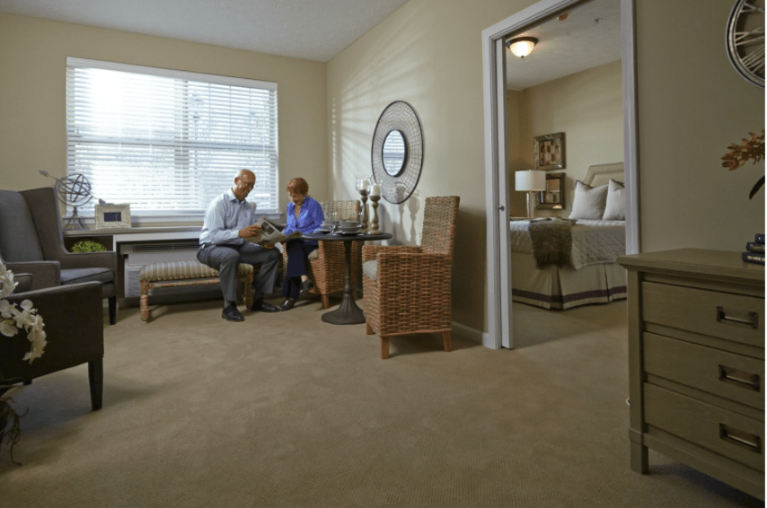 Two people sitting and talking in a cozy living room.