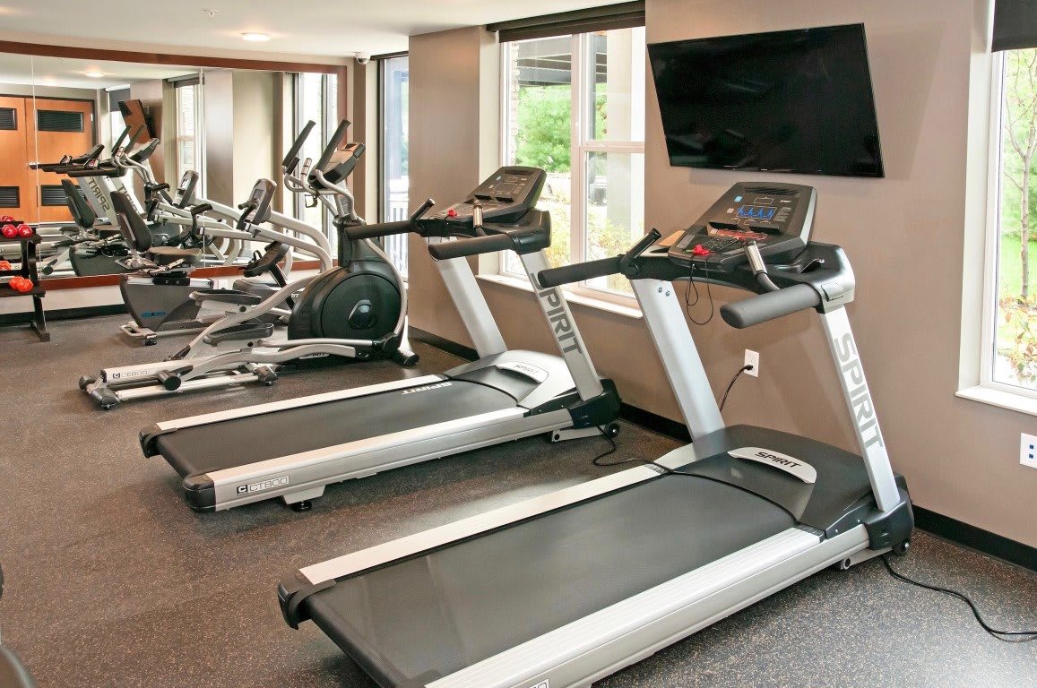 A modern gym with treadmills and exercise equipment.