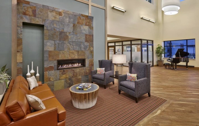 A cozy lobby area with modern furnishings and a fireplace.