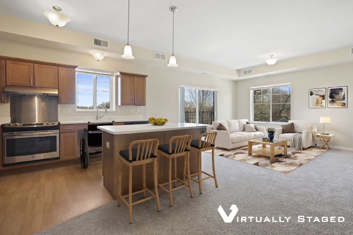 A modern open-concept kitchen and living room with an island counter and stylish decor.