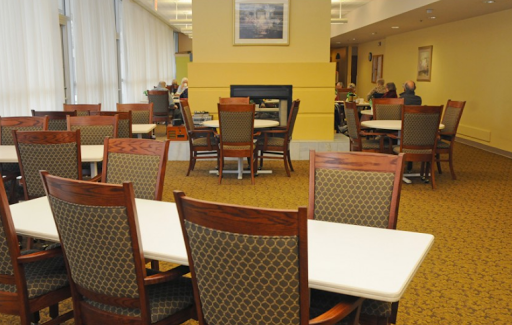 A quiet lounge area with tables and chairs, ideal for studying or relaxing.