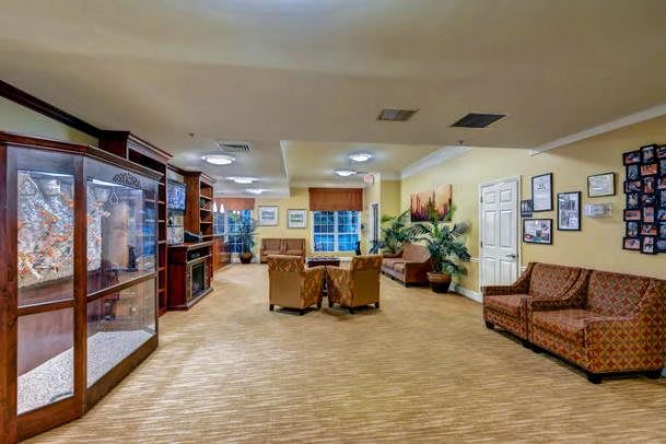 A spacious lounge area with comfortable seating and decorative elements.