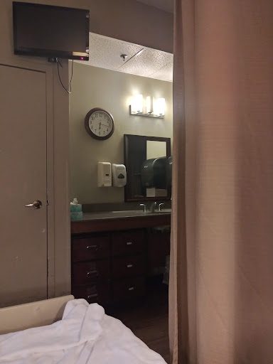 A glimpse of a hotel room with a view into the bathroom area.