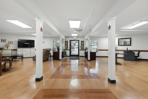 A welcoming lobby featuring wooden floors, bright lighting, and a modern aesthetic.
