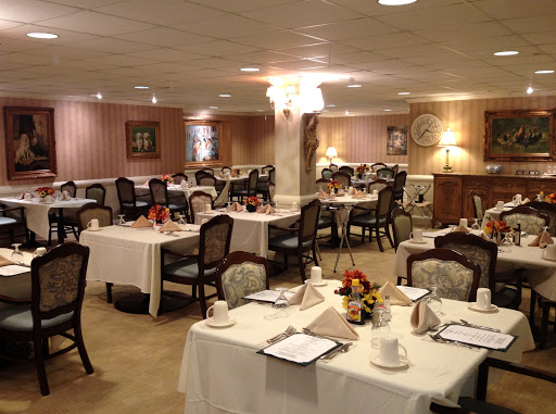 An elegantly arranged dining room with tables set for a formal meal.