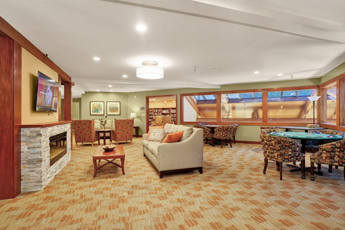 A cozy living room with comfortable seating and a warm fireplace.
