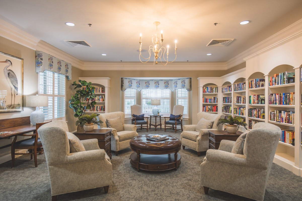 A cozy and elegant living room with comfortable seating and a chandelier.