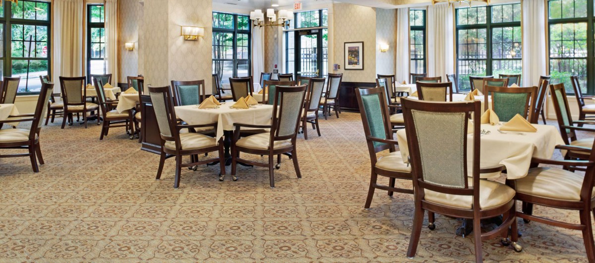An elegant dining room with neatly arranged tables and chairs.