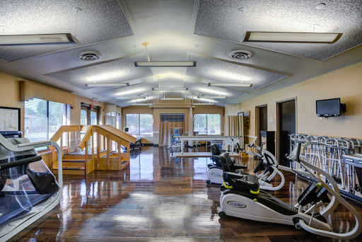 A spacious and well-equipped gym designed for fitness and rehabilitation.
