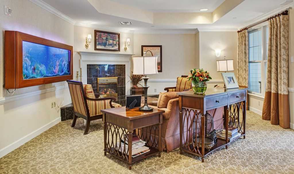 A cozy living room with comfortable seating and a warm fireplace.