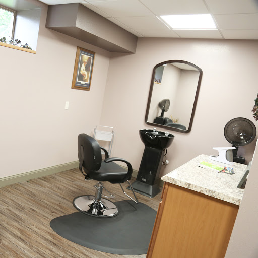 A neatly arranged hair salon featuring a styling chair, mirror, and clean workspace.
