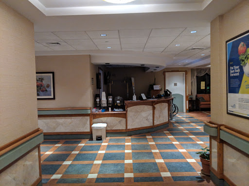 A spacious lobby area featuring a reception desk and colorful tiled flooring.