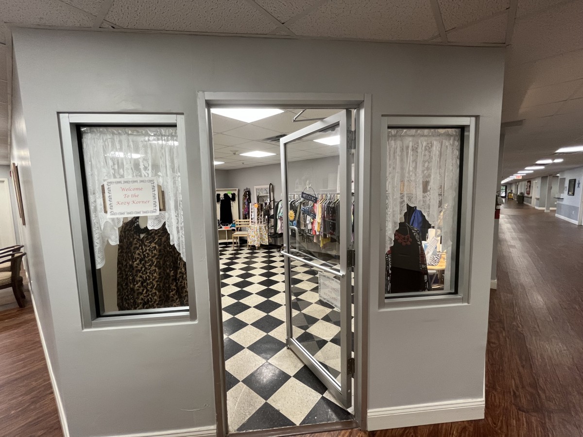 A stylish boutique with a checkered floor, displaying a variety of fashionable clothing items.