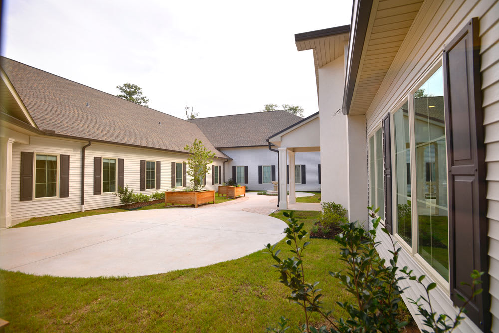 A modern house with a spacious courtyard and landscaped garden area.