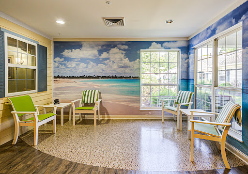 A serene waiting area featuring a beach mural, creating a calming environment for guests.