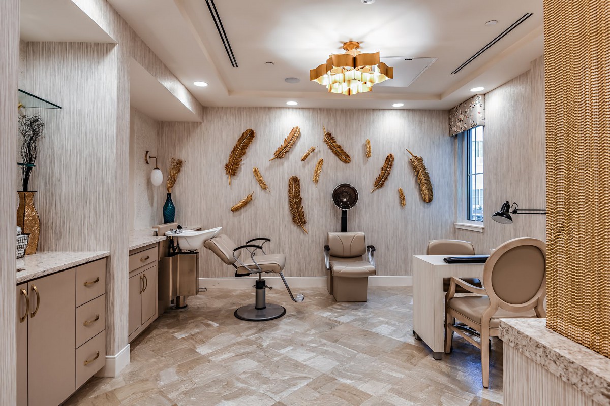 A stylish salon interior with modern furnishings and wall decor.