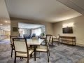 A modern dining room with a large table and chairs, emphasizing minimalistic interior design.