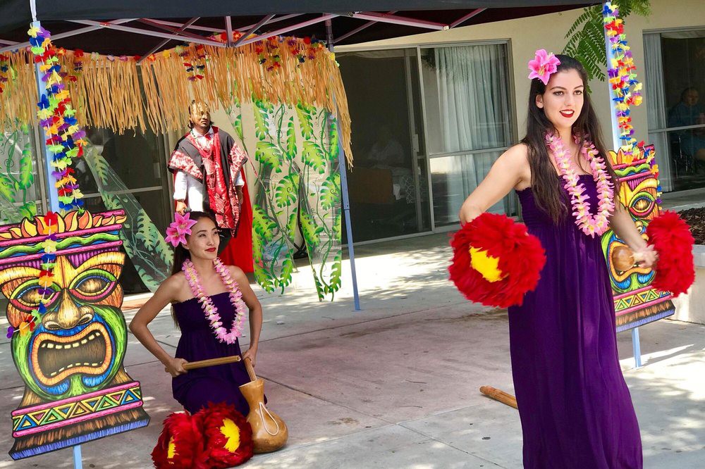 Performers in traditional Hawaiian attire during a cultural dance event.