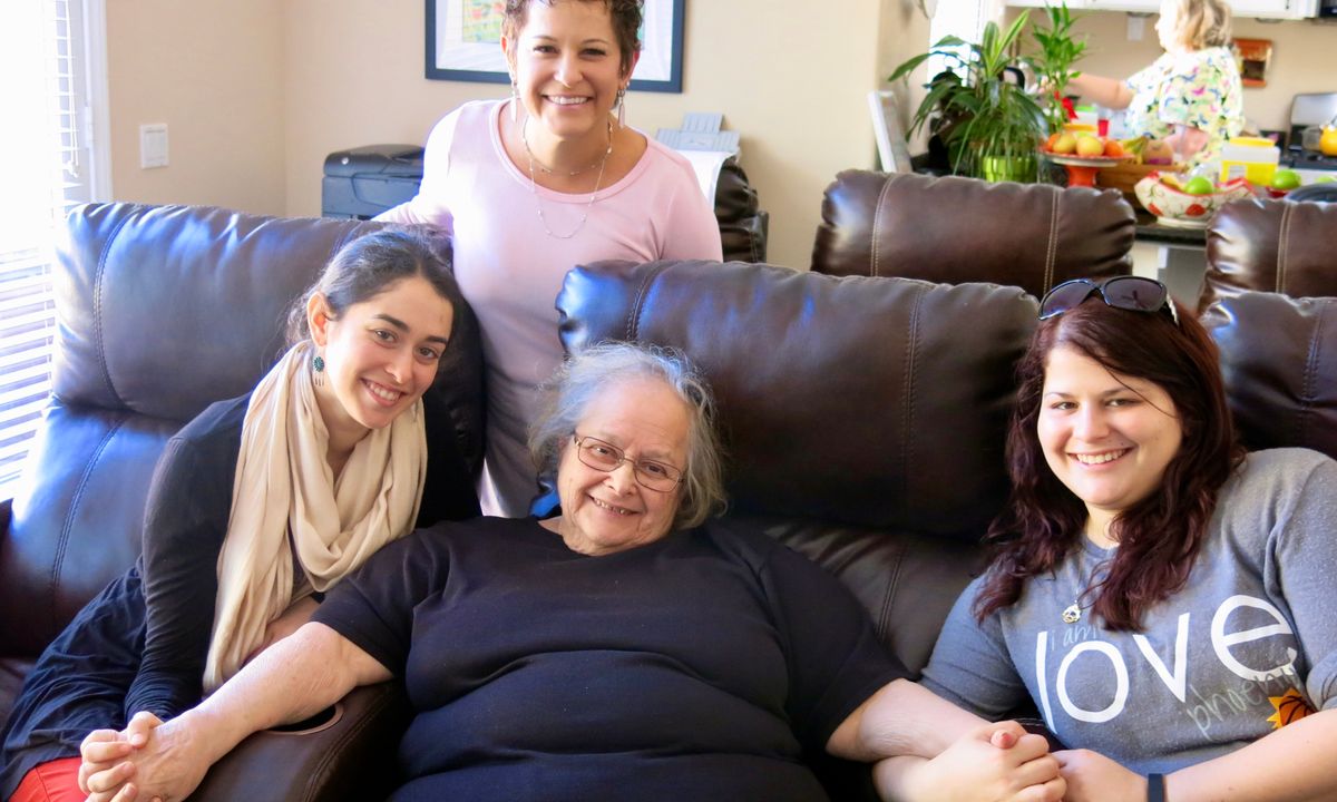 A group of people smiling together indoors.
