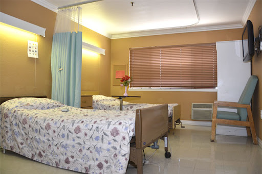 A cozy hospital room equipped with two beds, suitable for patient care.
