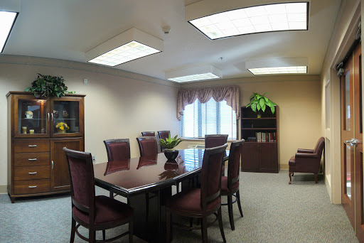 A spacious and elegantly furnished meeting room, equipped with a large conference table and comfortable seating.