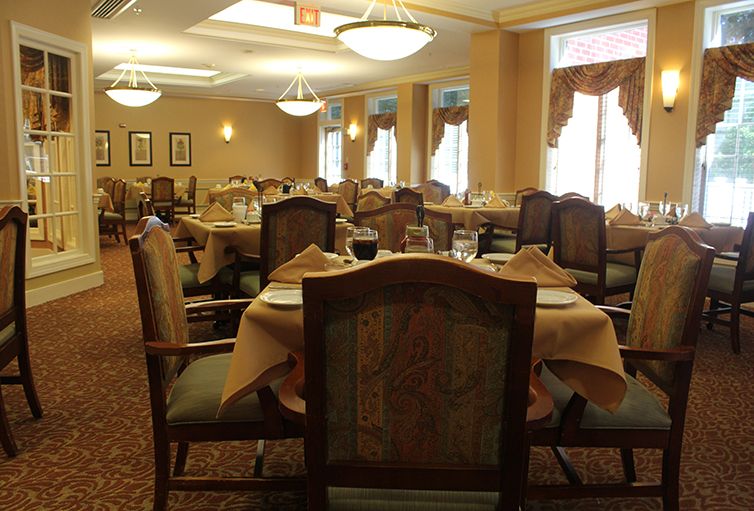 An elegant dining area with neatly arranged tables and chairs.