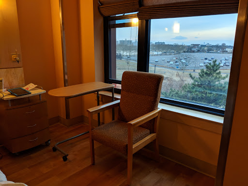 A cozy room featuring a comfortable chair by the window, offering a serene view of the ocean.
