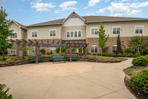 A welcoming residential building featuring a landscaped outdoor area with seating.