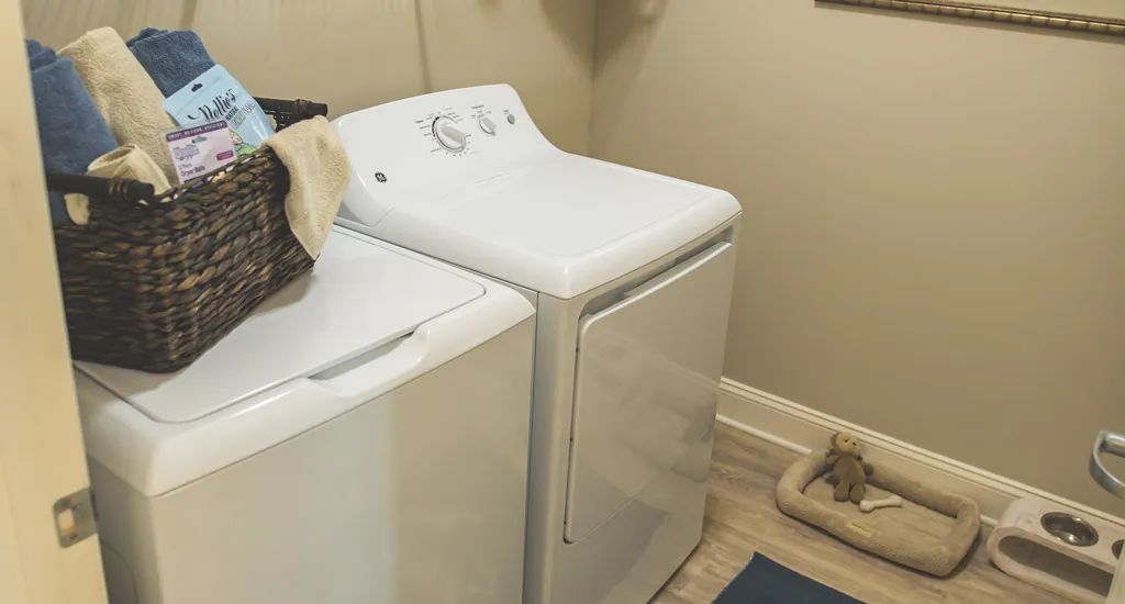 A laundry room with a washer and dryer side by side.