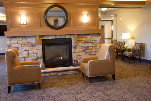 A cozy living room featuring a warm fireplace and comfortable seating, perfect for relaxation.