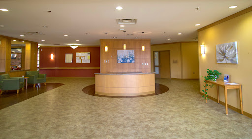 A spacious and well-lit lobby area featuring a reception desk and comfortable flooring.