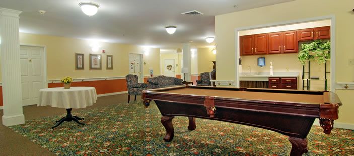 A cozy recreation room featuring a pool table and seating area.