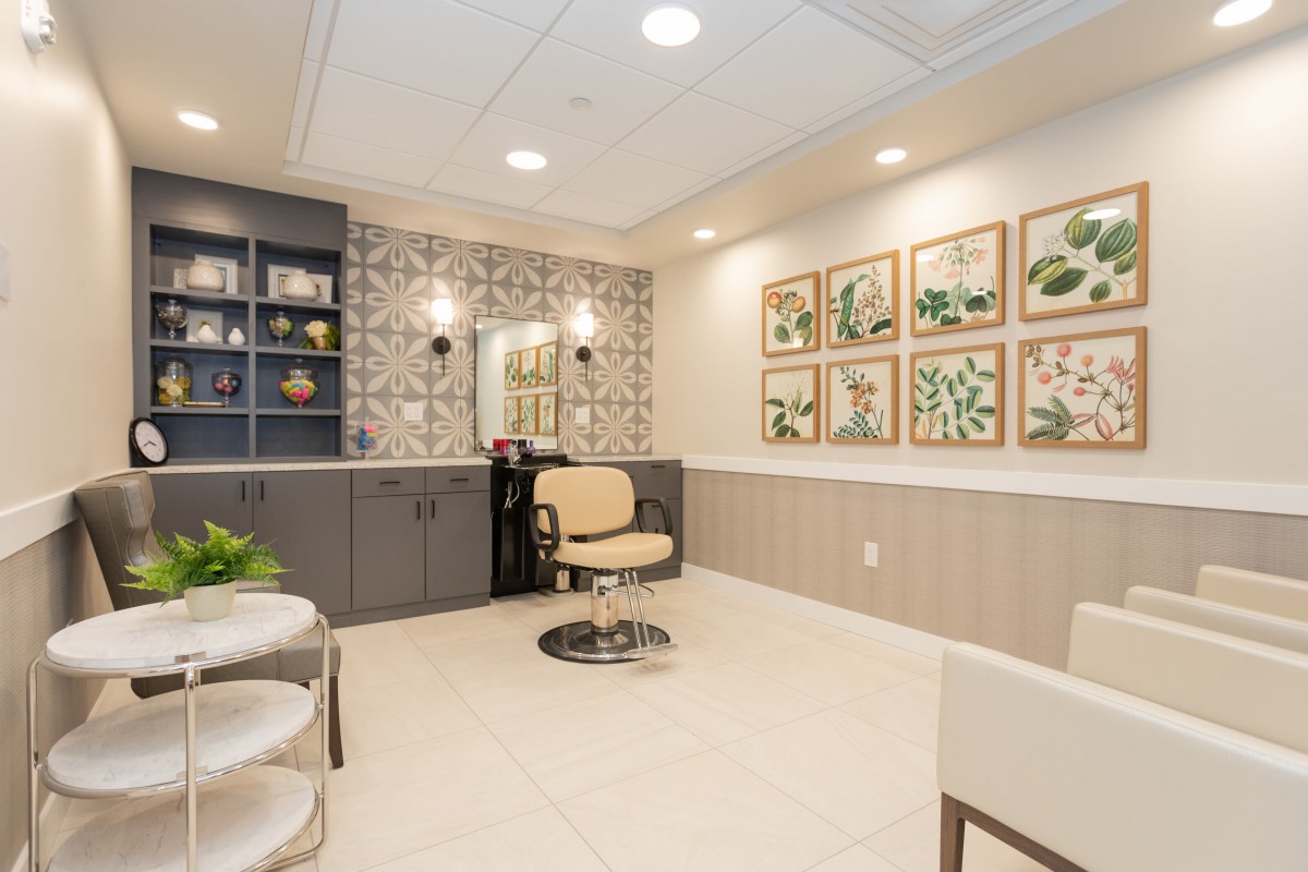 A well-decorated waiting room with comfortable seating and nature-themed artwork.