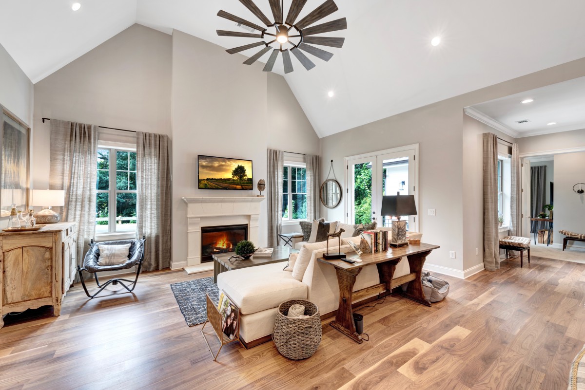 A modern living room with a cozy fireplace and stylish decor.