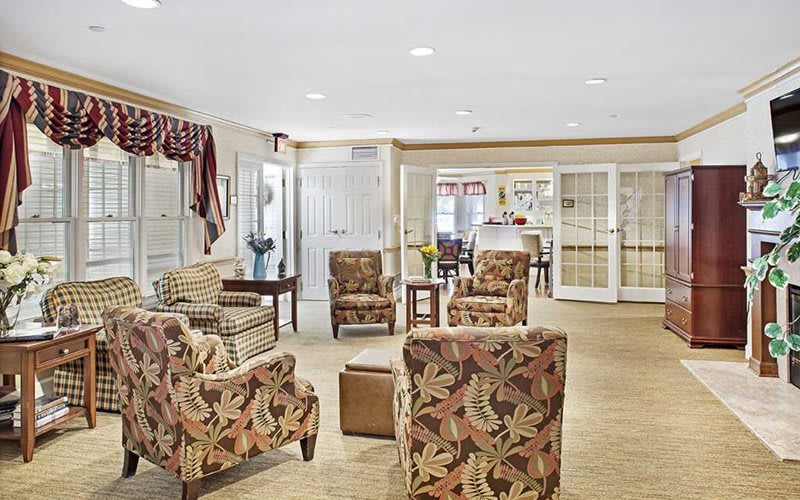 A cozy living room with patterned chairs and a neutral color scheme.