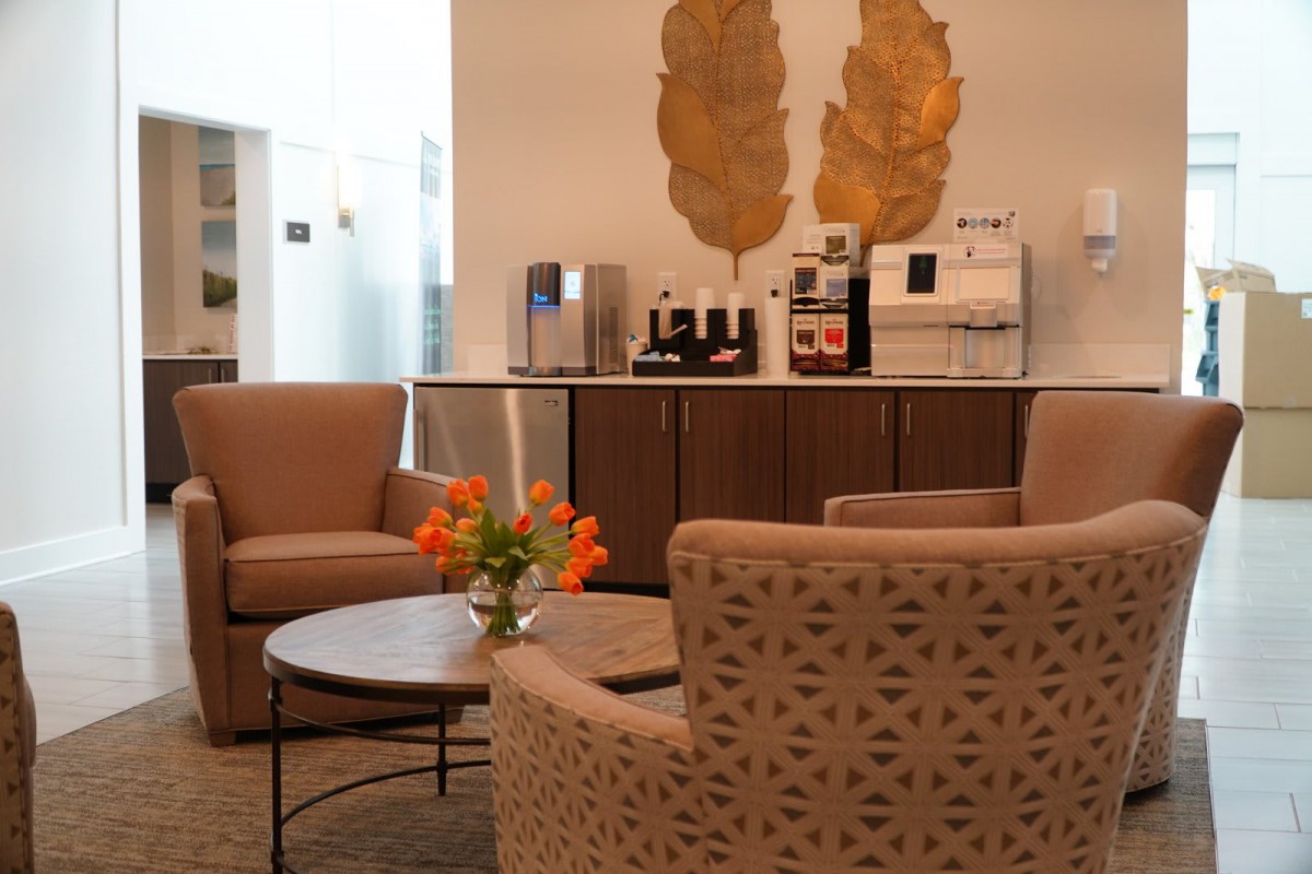 A cozy lounge area with comfortable seating and a coffee station.